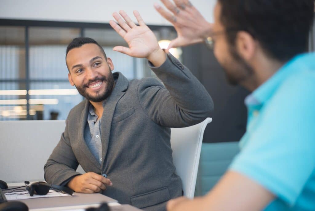 Photo by Kampus Production: https://www.pexels.com/photo/happy-office-workers-making-high-five-gesture-8204386/ -- product launch winning